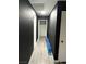 Long hallway with dark walls and gray floor at 4618 Zia Ridge St, North Las Vegas, NV 89031