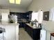 Well-equipped kitchen featuring dark wood cabinets and granite counters at 4618 Zia Ridge St, North Las Vegas, NV 89031