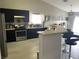 View of kitchen with stainless steel appliances, black cabinetry, breakfast bar, pendant lighting, and modern stove at 4618 Zia Ridge St, North Las Vegas, NV 89031