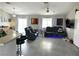 Open concept living room with gray floors and black theater seating at 4618 Zia Ridge St, North Las Vegas, NV 89031