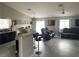 Bright, open concept living room featuring wood-look floors, a breakfast bar, and modern furniture at 4618 Zia Ridge St, North Las Vegas, NV 89031