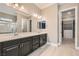 Double vanity bathroom with dark cabinets and walk-in closet at 473 Harvest Rain Ave, Henderson, NV 89011