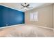 Spacious bedroom with ceiling fan and blue accent wall at 473 Harvest Rain Ave, Henderson, NV 89011