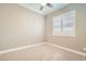 Bright bedroom with neutral walls and carpet, featuring a large window with plantation shutters at 473 Harvest Rain Ave, Henderson, NV 89011