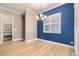 Bright dining room with blue accent wall and plantation shutters at 473 Harvest Rain Ave, Henderson, NV 89011