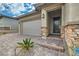 House exterior with stone accents and a paved driveway at 473 Harvest Rain Ave, Henderson, NV 89011