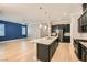 Modern kitchen with island, dark cabinets, and granite countertops at 473 Harvest Rain Ave, Henderson, NV 89011