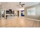 Bright living room with hardwood floors, ceiling fan, and an accent wall at 473 Harvest Rain Ave, Henderson, NV 89011