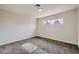 Simple bedroom with carpet flooring and large window at 5129 Del Monte Ave, Las Vegas, NV 89146