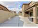 Private backyard with concrete patio and tall fence at 521 Abrazar Ave, North Las Vegas, NV 89081