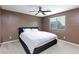 Spacious bedroom with ceiling fan and large bed at 521 Abrazar Ave, North Las Vegas, NV 89081