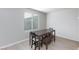 Simple dining room with table, bench, and two chairs at 521 Abrazar Ave, North Las Vegas, NV 89081