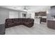 Open living room with L-shaped sectional sofa and kitchen view at 521 Abrazar Ave, North Las Vegas, NV 89081