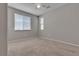 A simple bedroom with carpeted floors, ceiling fan, and window with blinds at 5233 Fiery Sky Ridge St, Las Vegas, NV 89148