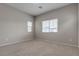 Bright bedroom featuring neutral walls and carpet at 5233 Fiery Sky Ridge St, Las Vegas, NV 89148