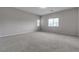 Spacious bedroom with carpeted floors and window at 5233 Fiery Sky Ridge St, Las Vegas, NV 89148