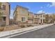 Two-story home with stucco siding, stone accents, paved driveway, and an attached two-car garage at 5233 Fiery Sky Ridge St, Las Vegas, NV 89148