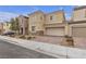 Two-story house with beige exterior, two-car garage, and landscaped front yard at 5233 Fiery Sky Ridge St, Las Vegas, NV 89148