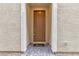 Brown front door entryway with a welcome mat at 5233 Fiery Sky Ridge St, Las Vegas, NV 89148