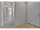 Hallway with tiled floor leading to other rooms, and a white entry door at 5233 Fiery Sky Ridge St, Las Vegas, NV 89148