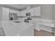 A modern kitchen featuring white cabinetry, stainless steel appliances and solid surface countertops at 5233 Fiery Sky Ridge St, Las Vegas, NV 89148