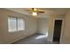 Bright bedroom with carpeted floors and a large window at 5576 W Rochelle Ave # 25C, Las Vegas, NV 89103