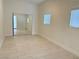 Bedroom with tile floors, mirrored closet doors, and two windows at 624 D Ave, Boulder City, NV 89005