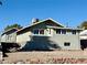 Gray house with a smaller building in the back, and a gravel yard at 624 D Ave, Boulder City, NV 89005