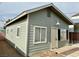 Small gray guest house with white trim, windows, and a door at 624 D Ave, Boulder City, NV 89005