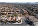 Aerial view of a house in a residential neighborhood with a pool and solar panels at 6420 Birdcall St, North Las Vegas, NV 89084