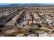 Aerial view showcasing a residential neighborhood near a park and mountains at 6420 Birdcall St, North Las Vegas, NV 89084