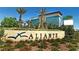 Aliante Station Casino plus blue and gold entrance signage framed by lush green desert foliage at 6420 Birdcall St, North Las Vegas, NV 89084