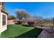 Artificial turf backyard with decorative accents at 6420 Birdcall St, North Las Vegas, NV 89084