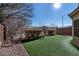 Landscaped backyard with artificial turf and gravel at 6420 Birdcall St, North Las Vegas, NV 89084