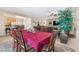 Formal dining room with a dark wood table, red tablecloth, and six chairs at 6420 Birdcall St, North Las Vegas, NV 89084