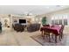 Dining area with a wood table and chairs, and a view into the living room at 6420 Birdcall St, North Las Vegas, NV 89084