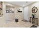 Bright and spacious entryway with tile flooring and a coat rack at 6420 Birdcall St, North Las Vegas, NV 89084