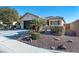 One-story home with desert landscaping and a two-car garage at 6420 Birdcall St, North Las Vegas, NV 89084