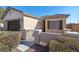 Front entrance of the house with a gate and well-maintained landscaping at 6420 Birdcall St, North Las Vegas, NV 89084