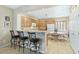 Kitchen with light wood cabinets, a breakfast bar, and a round table at 6420 Birdcall St, North Las Vegas, NV 89084