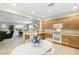 Bright kitchen with light wood cabinets, an island, and a view into the adjacent Gathering room at 6420 Birdcall St, North Las Vegas, NV 89084