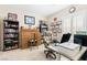 Home office with built-in desk, comfortable chair, and ample shelving at 6420 Birdcall St, North Las Vegas, NV 89084