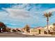 Serenata community street view shows well-maintained homes, palm tree, and beautiful blue sky at 6420 Birdcall St, North Las Vegas, NV 89084