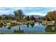 Serene water view reflects lush landscaping with snow-capped mountains in the distance at 6420 Birdcall St, North Las Vegas, NV 89084