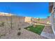 Landscaped backyard with artificial turf, rock accents, and a sitting area at 6542 Coffee Theme St # Lot 12, North Las Vegas, NV 89084