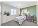 Well-lit bedroom with green accent wall and desk at 6542 Coffee Theme St # Lot 12, North Las Vegas, NV 89084