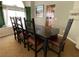 Formal dining room with dark wood table and six leather chairs at 656 Hidden Cellar Ct, Las Vegas, NV 89183