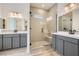 Modern bathroom with double vanity, frameless glass shower, tiled walls, and contemporary fixtures for a spa-like experience at 66 Ibiza Lake Dr, Henderson, NV 89011