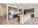 Well-lit kitchen featuring an island, stainless steel appliances, gray cabinets, and sleek countertops at 66 Ibiza Lake Dr, Henderson, NV 89011