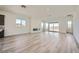 Spacious living room with wood-look floors, a modern fireplace, recessed lighting and large sliding glass doors at 66 Ibiza Lake Dr, Henderson, NV 89011